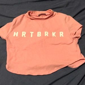 crop top shirt it says hrtbrkr (heartbreaker).